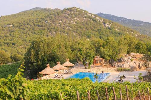 a resort with a swimming pool and a mountain at Stanic Estate in Ljubuški