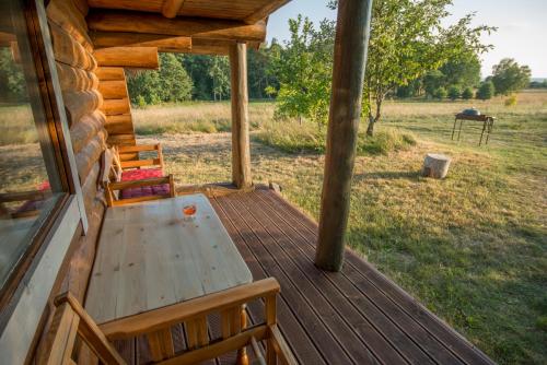 a wooden deck with a table and chairs on a cabin at Northern Zen in Kaunispe