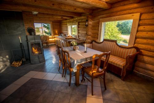 a dining room with a table and a fireplace at Northern Zen in Kaunispe