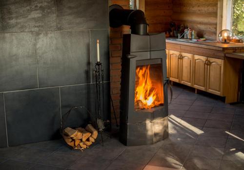 a stove in a kitchen with a fire in it at Northern Zen in Kaunispe