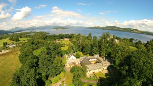 an aerial view of a mansion with a lake at Stables Lodge in Balloch