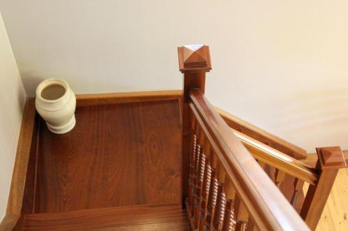 a wooden staircase with a vase on the side of it at Stables Lodge in Balloch