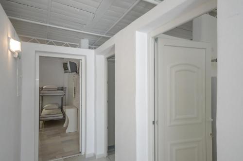 a hallway with a white door and a closet at Hostel Naxos Camping in Naxos Chora