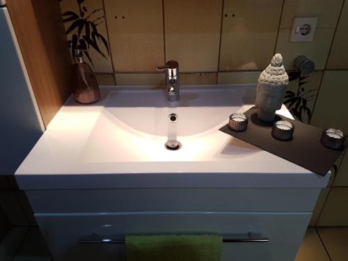 a bathroom sink with a light on top of it at Ferienhaus Sieglinde in Erden