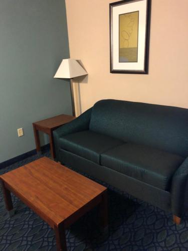 a living room with a couch and a table at Countryview Inn & Suites in Robinson