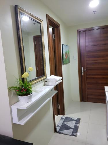 a bathroom with a sink and a mirror at KC Studio 2 at Horizon 101 Cebu in Cebu City