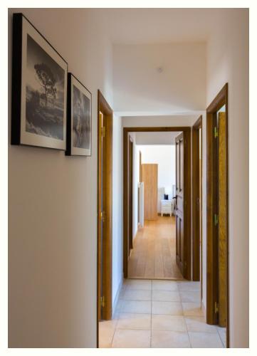a hallway with two doors and a tile floor at Villa 4 étoiles Sole di Corsica in Cauro