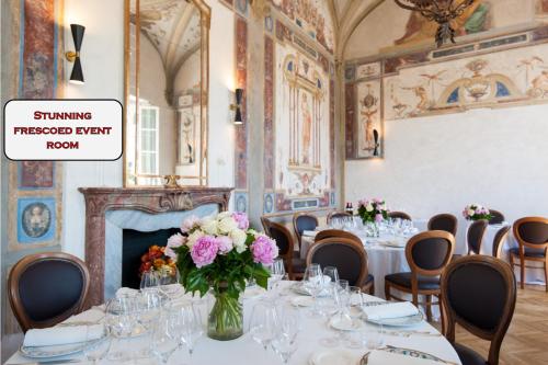 a room with a table with a vase of flowers at Hotel Lungarno Vespucci 50 in Florence