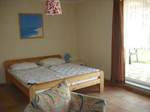 מיטה או מיטות בחדר ב-Boddenperle
