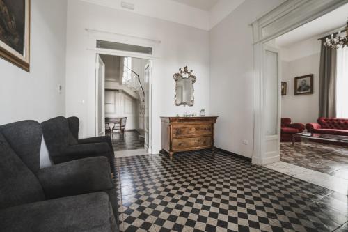 a living room with a couch and a checkered floor at Villa Giordanelli in Scalea