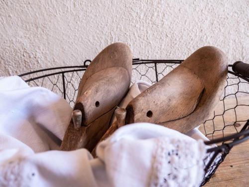 a pair of shoes sitting on a bed at Landhaus Strickenmacher in Sillian
