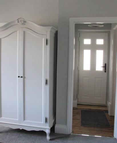 a room with a white closet with a door at Farfield in Threshfield