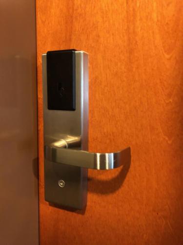 a metal door handle on a wooden door at Countryview Inn & Suites in Robinson