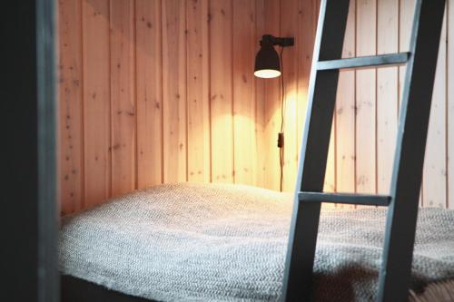 a room with a bed with a ladder and a lamp at Hilltop Cabin Hekla - Golden Circle - Geysir - Mountain View in Reykholt