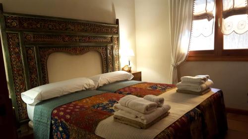 a bedroom with a bed with towels on it at Casa Bonita Navacerrada in Navacerrada