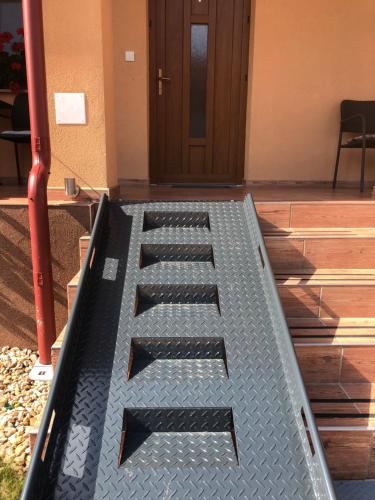 a metal letter e sitting on the steps of a building at Vila Mária Rapovce in Rapovce