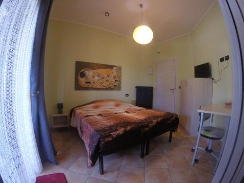 a bedroom with a bed and a table in a room at Il Roseto di Daniela in Montefiascone
