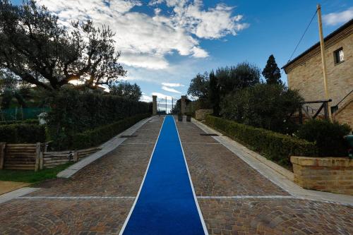 a long pathway with blue water in the middle at Agriturismo Il Sapore Della Luna in Monteprandone