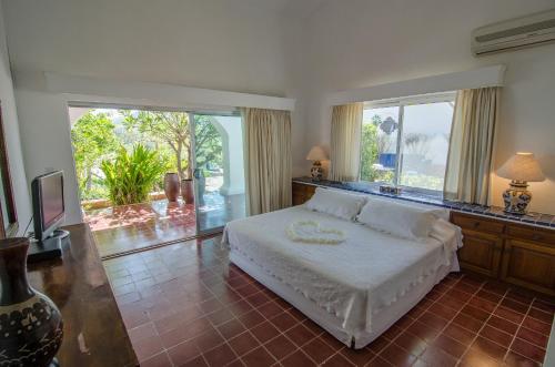 a bedroom with a bed and a large window at Rancho Las Cruces in Las Cruces