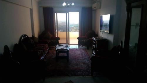 a dark room with a living room with a television at Mahdy Apartment in Alexandria