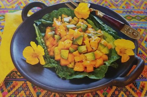 a plate of food with a salad on a table at Rancho Las Cruces in Las Cruces