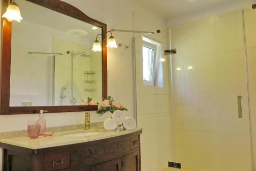 a bathroom with a sink and a shower with a mirror at ARILLAS HILLSIDE VILLA 3 - Provence in Arillas