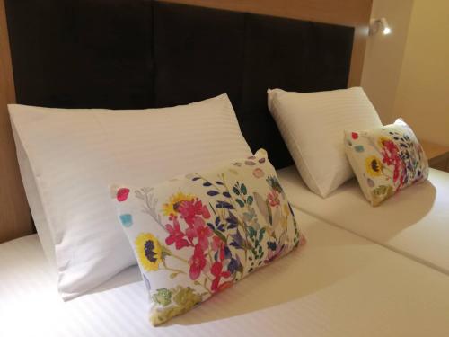 two pillows sitting on top of a bed at Stami's Seaside Apartment in Pyrgi