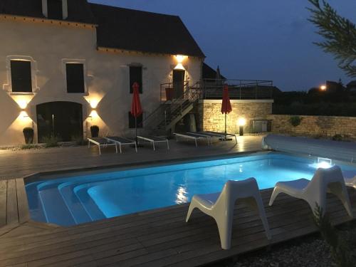 une villa avec une piscine la nuit dans l'établissement La Maison des Rugiens, à Pommard
