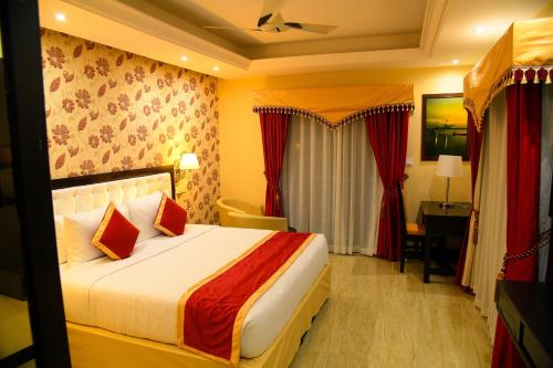 a hotel room with a bed and a desk at Sajjoys in Varkala