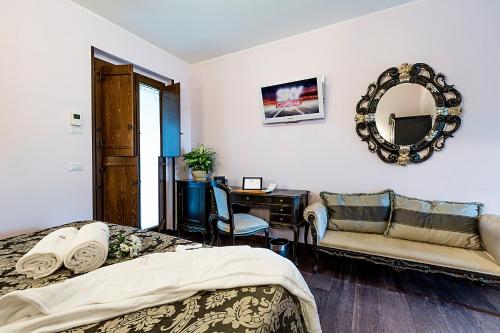 a bedroom with a bed and a desk and a mirror at Agriturismo Il Sapore Della Luna in Monteprandone