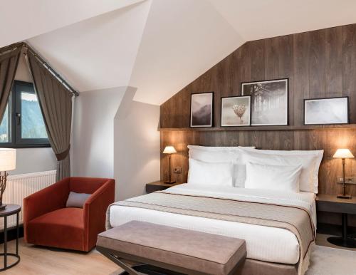 a hotel room with a bed and a chair at Ilgaz Mountain Resort Hotel in Ilgaz