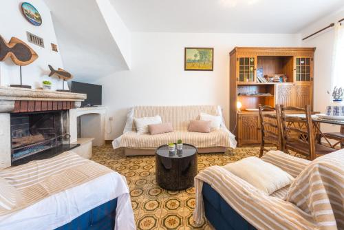 a living room with a couch and a fireplace at Bace Apartments in Klek