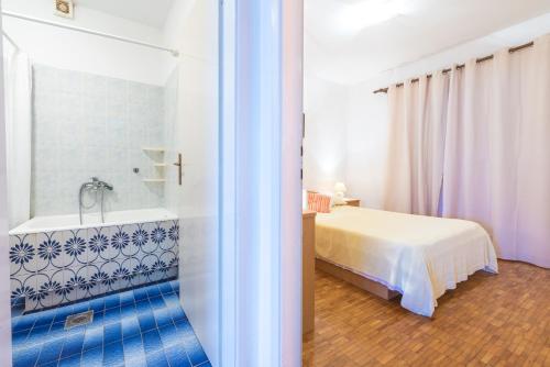 a bathroom with a bed and a bath tub in a room at Bace Apartments in Klek