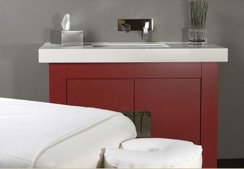a bathroom with a red cabinet with a sink at Auberge Saint-Antoine in Quebec City
