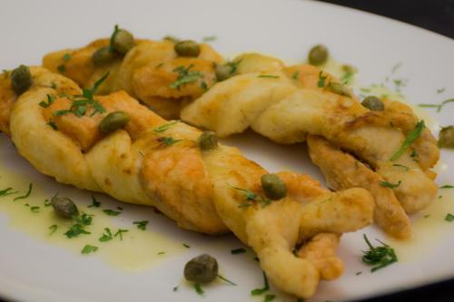 a plate of food with shrimp and greens on it at Ritz Apart Hotel in La Paz