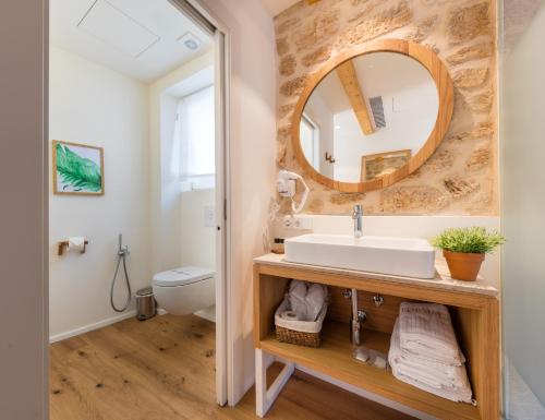 a bathroom with a sink and a mirror at Forum Boutique Hotel & Spa - Adults Only in Alcudia