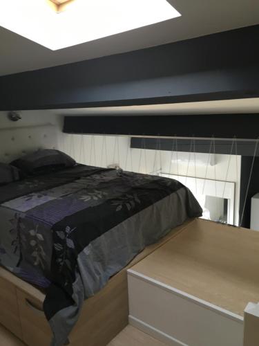 a bed in the middle of a room at Villa ou studio indépendant PISCINE sans vis à vis in Mudaison