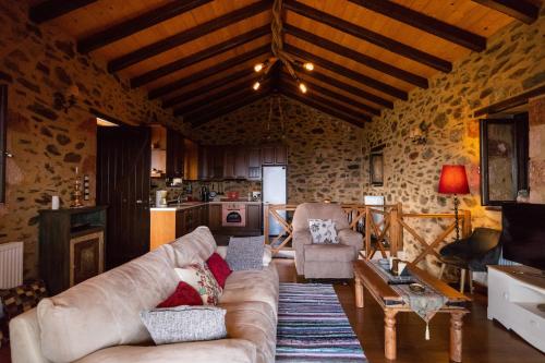 a living room with a couch and a table at Luxury House In The Hills in Sparti