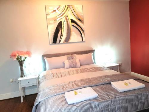 a bedroom with a bed with two towels on it at Gabriel Guesthouse in Rhyl
