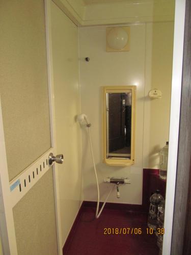 a bathroom with a sink and a mirror at Guest House Chara in Hirosaki