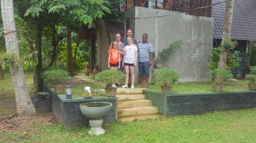 a group of people standing in front of a house at Elegant Hamlets Home Stay in Chilaw