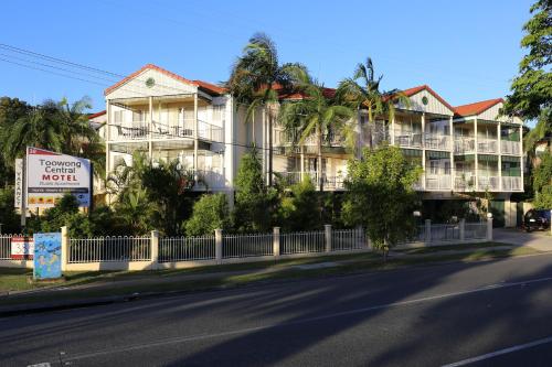 a building on the side of a street with a fence at Toowong Central Motel Apartments in Brisbane