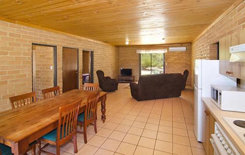 a kitchen and dining room with a table and chairs at Turner Brook Chalet in Augusta