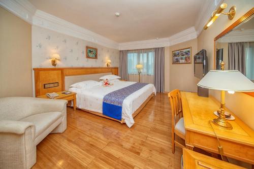 a hotel room with a bed and a desk at Hotel Silverland in Dongguan