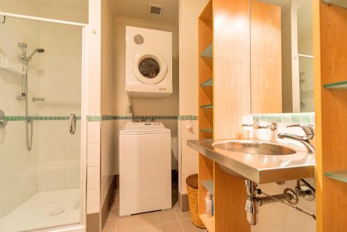 a bathroom with a sink and a shower at QV Private Absolute Waterfront Auckland - 263 in Auckland