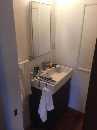 a bathroom with a sink and a mirror at Bimini Seaside Villas - Pink Cottage with Beach View in Alice Town