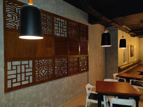 a dining room with a table and some lights at The Bull Boutique Hotel in Puducherry