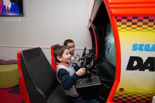 a young boy playing a video game in a toy truck at Macquarie 4 Star in Warners Bay
