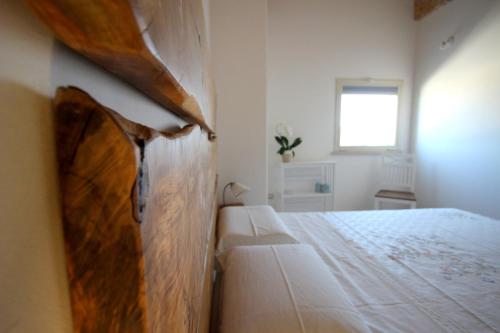 a bedroom with a bed and a window at Home Holiday Salento Casa Belvedere in Specchia