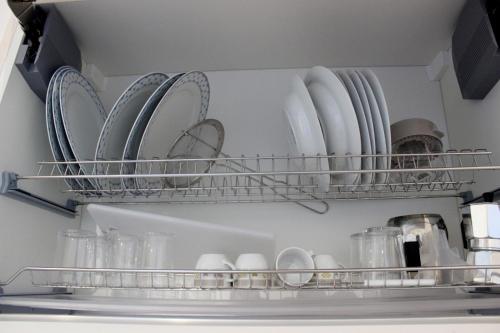 a refrigerator filled with plates and cups and dishes at Home Holiday Salento Casa Belvedere in Specchia